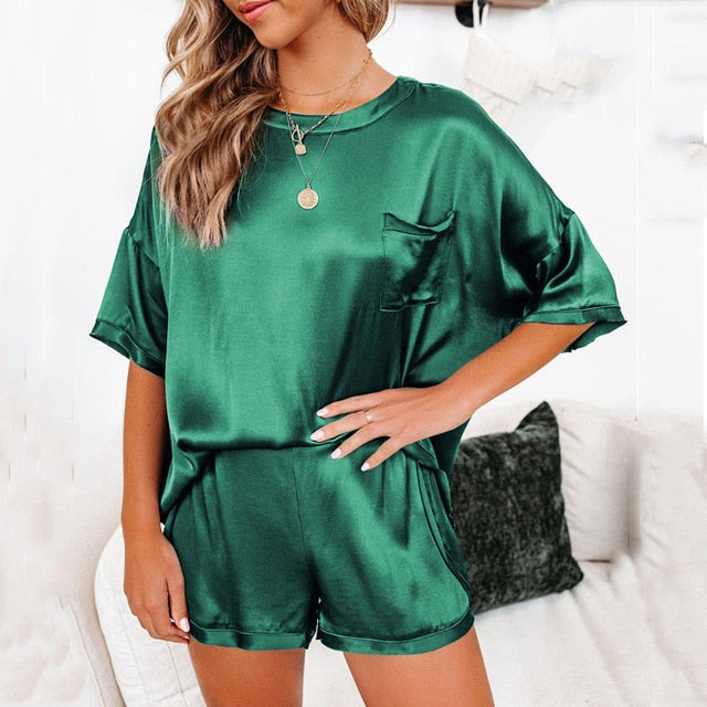 a woman wearing a green satin short set