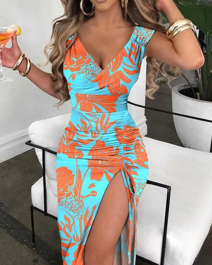 a woman in a blue and orange dress holding a wine glass