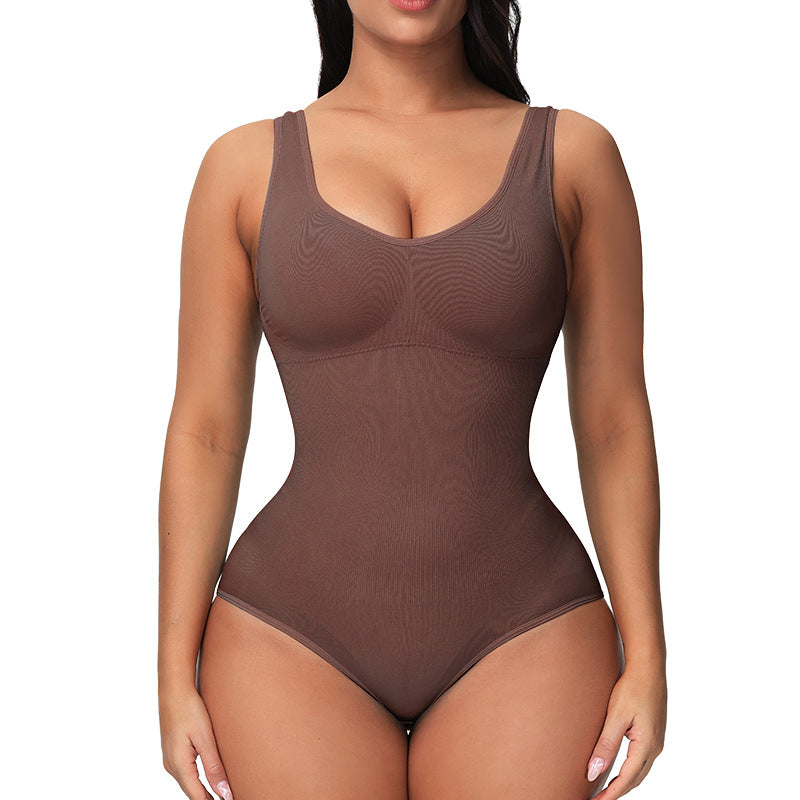 a woman in a brown bodysuit posing for the camera