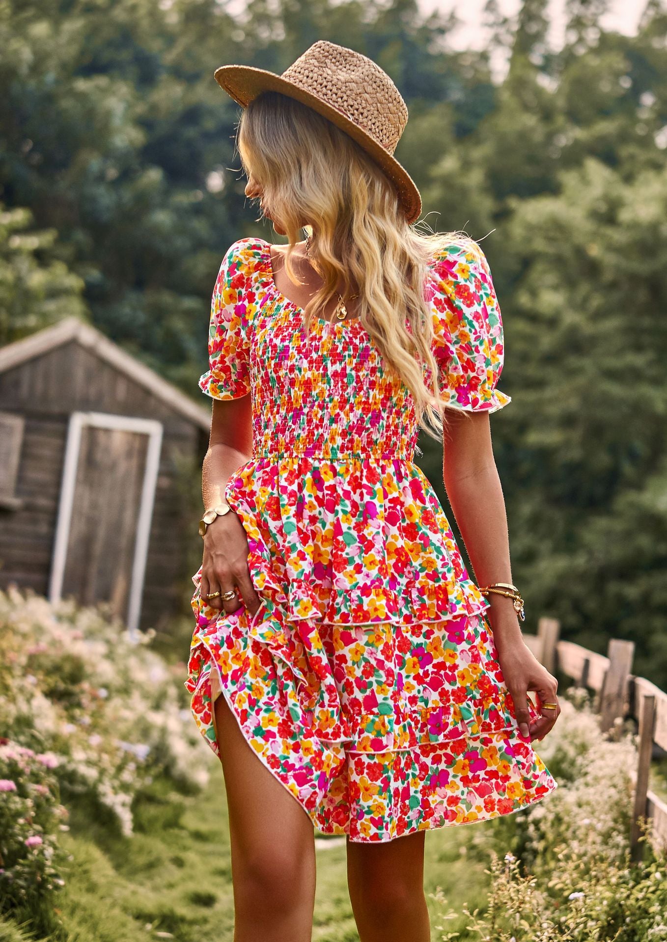 a woman in a colorful dress and straw hat