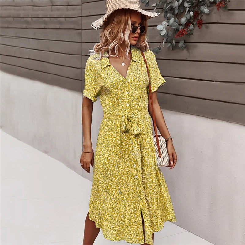 a woman wearing a yellow dress and a straw hat