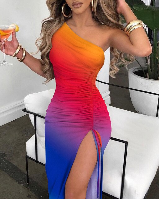 a woman in a colorful dress holding a drink