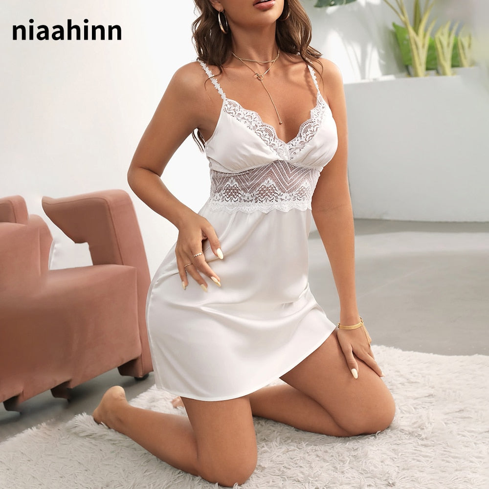 a woman sitting on the floor in a white dress